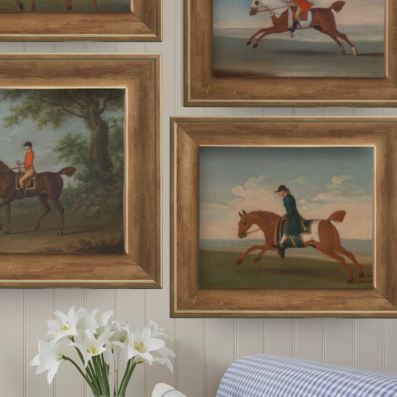 Grouping of vintage-inspired equestrian and landscape art prints on a wall