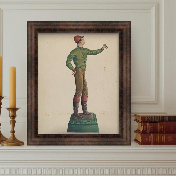 Framed artwork of a figure on a pedestal against a white wall with decorative molding.