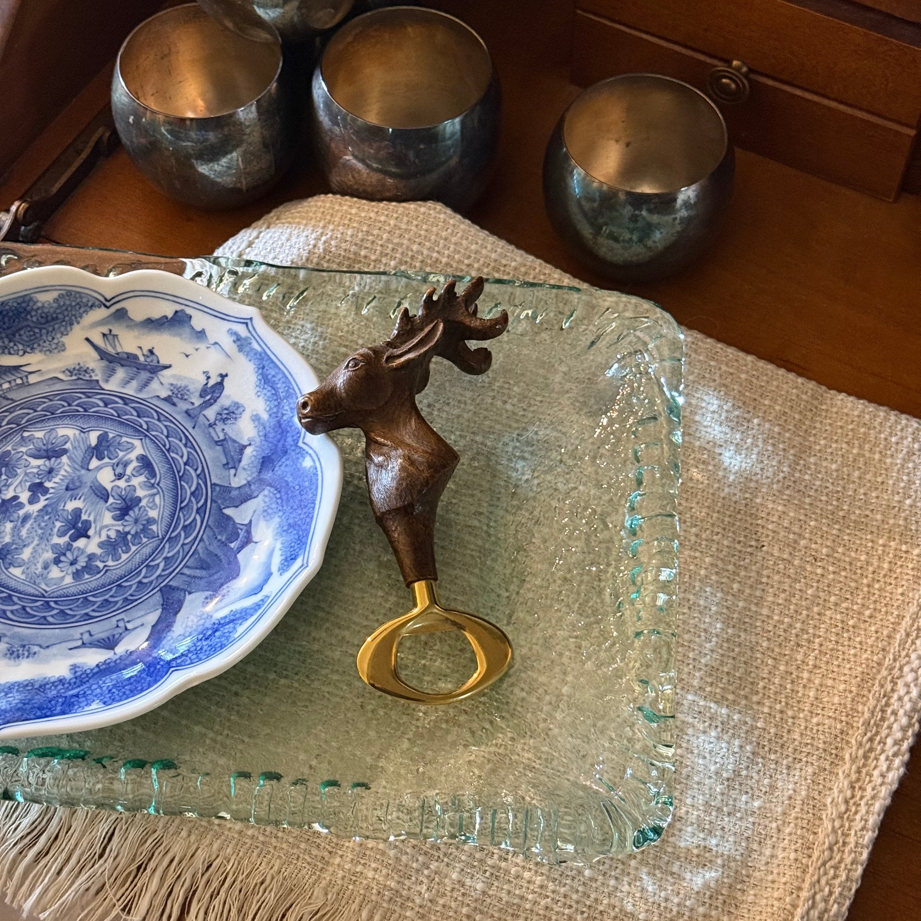 Angled shot of the Comoy's of London deer head bottle opener showing the detailed sculpting and Italian-designed resin handle.