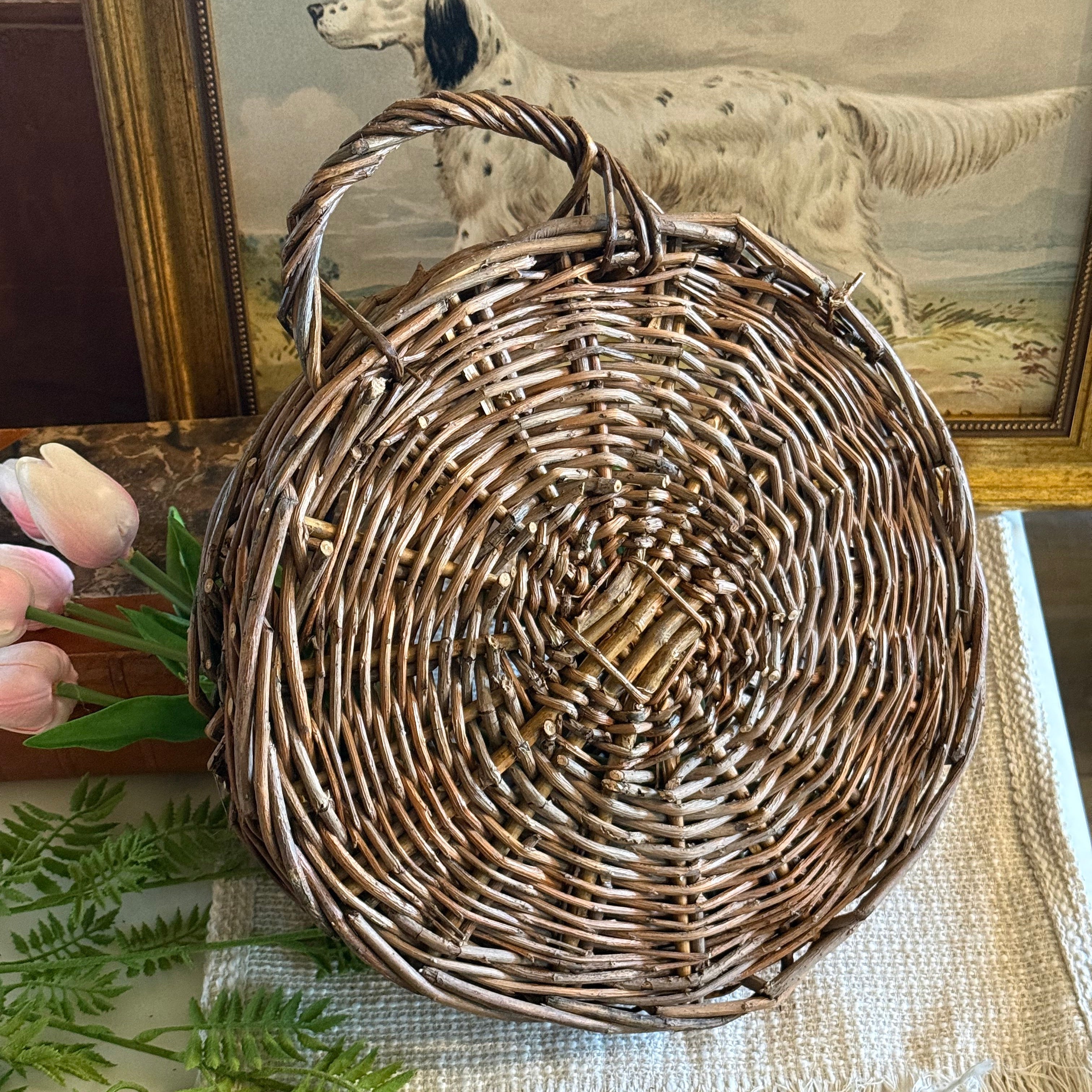 Woven basket on a surface with decorative elements in the background