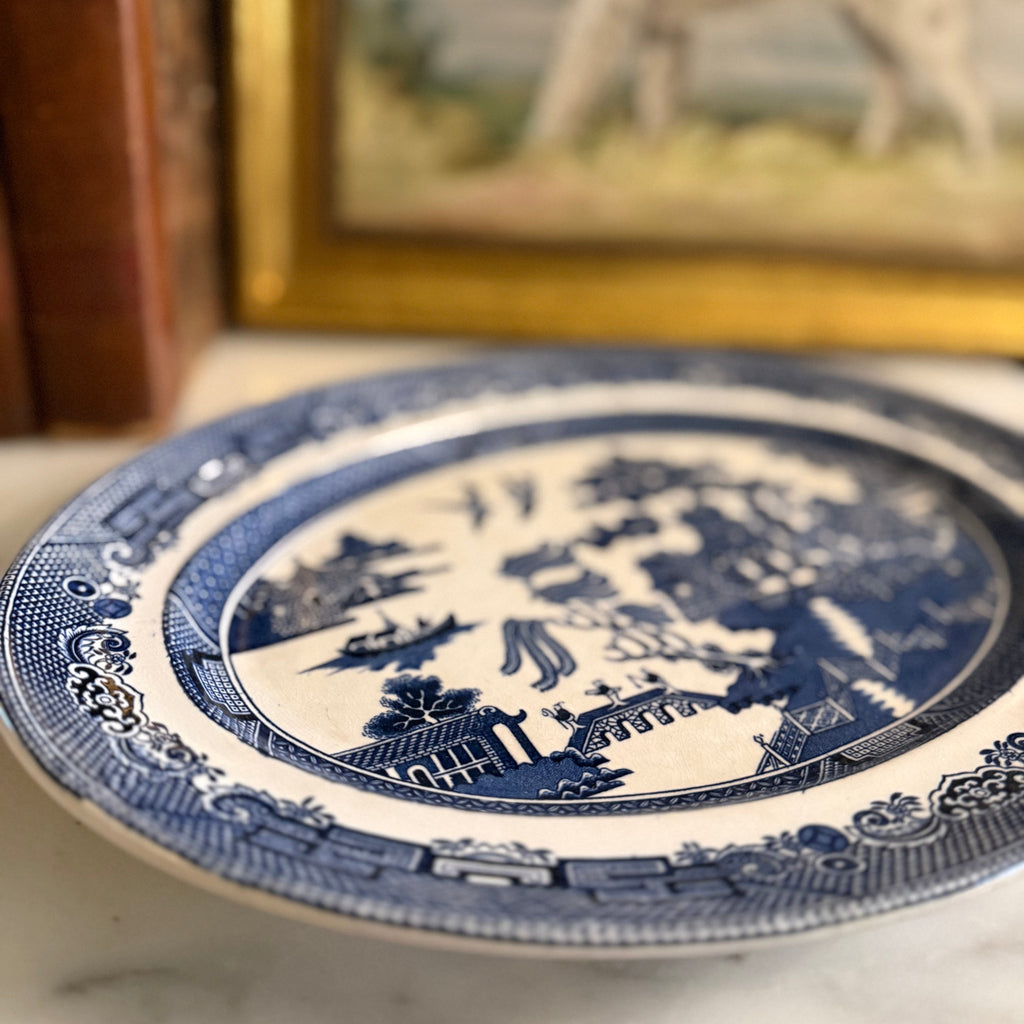 Top-down view of the Johnson Bros Blue Willow platter on a marble tabletop