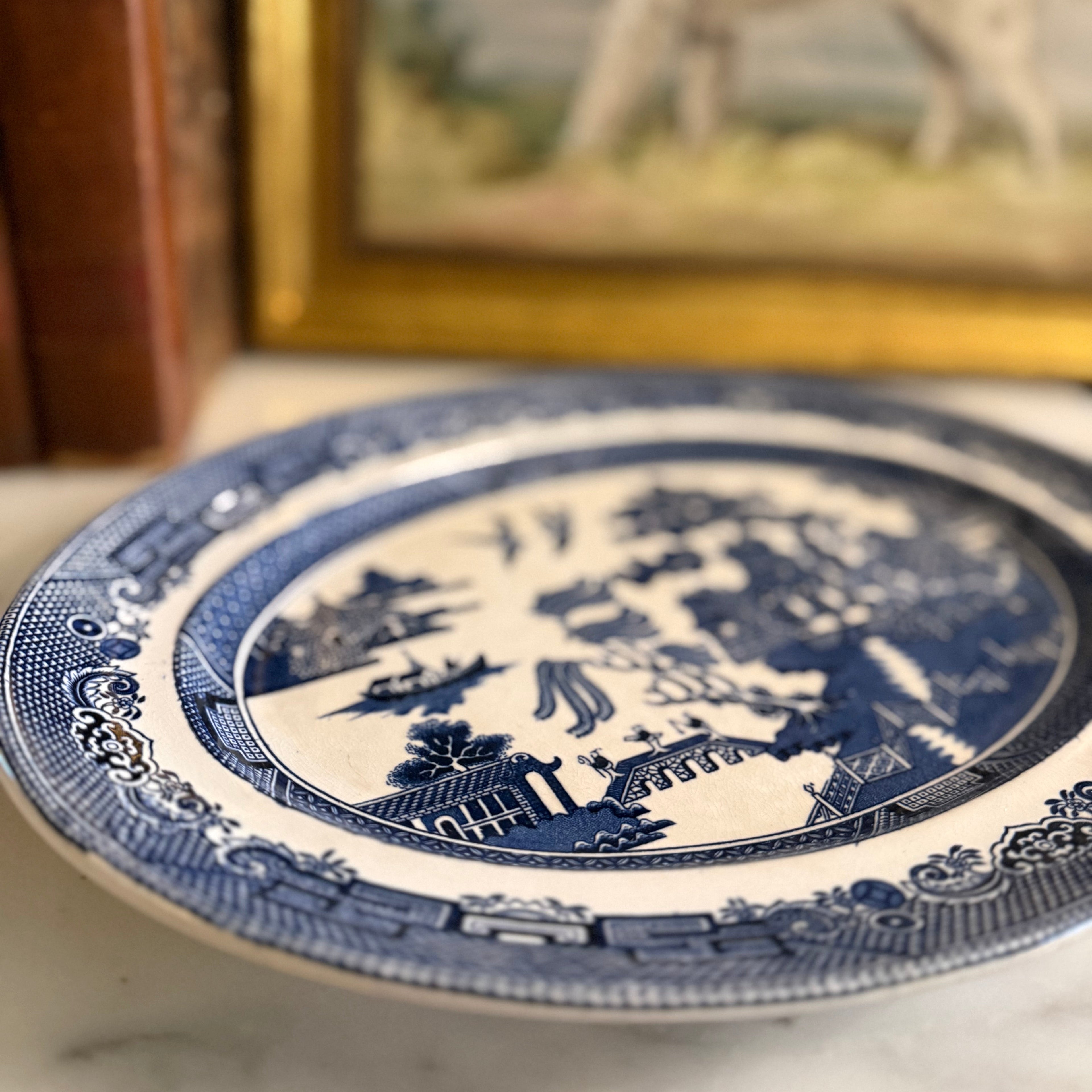 Top-down view of the Johnson Bros Blue Willow platter on a marble tabletop