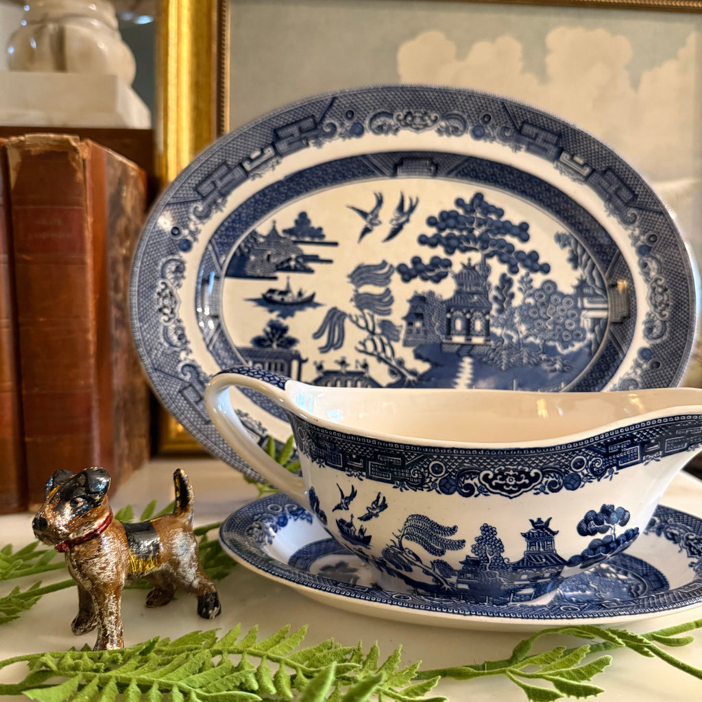 The Blue Willow gravy boat set styled with fresh greenery for a classic table setting