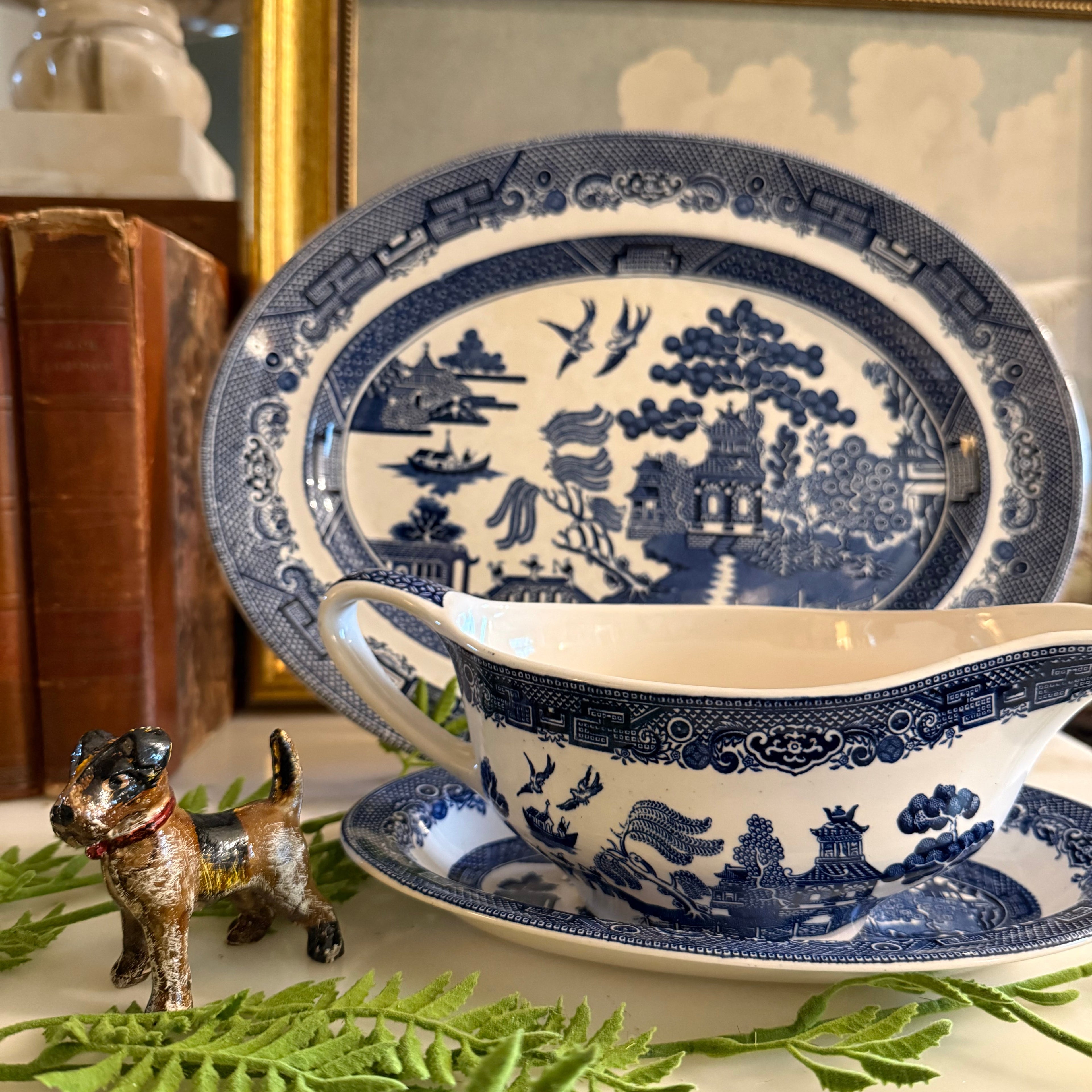 The Blue Willow gravy boat set styled with fresh greenery for a classic table setting