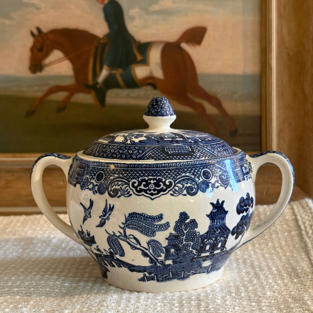 Detail view of the cobalt blue willow transferware pattern on an English lidded sugar bowl.