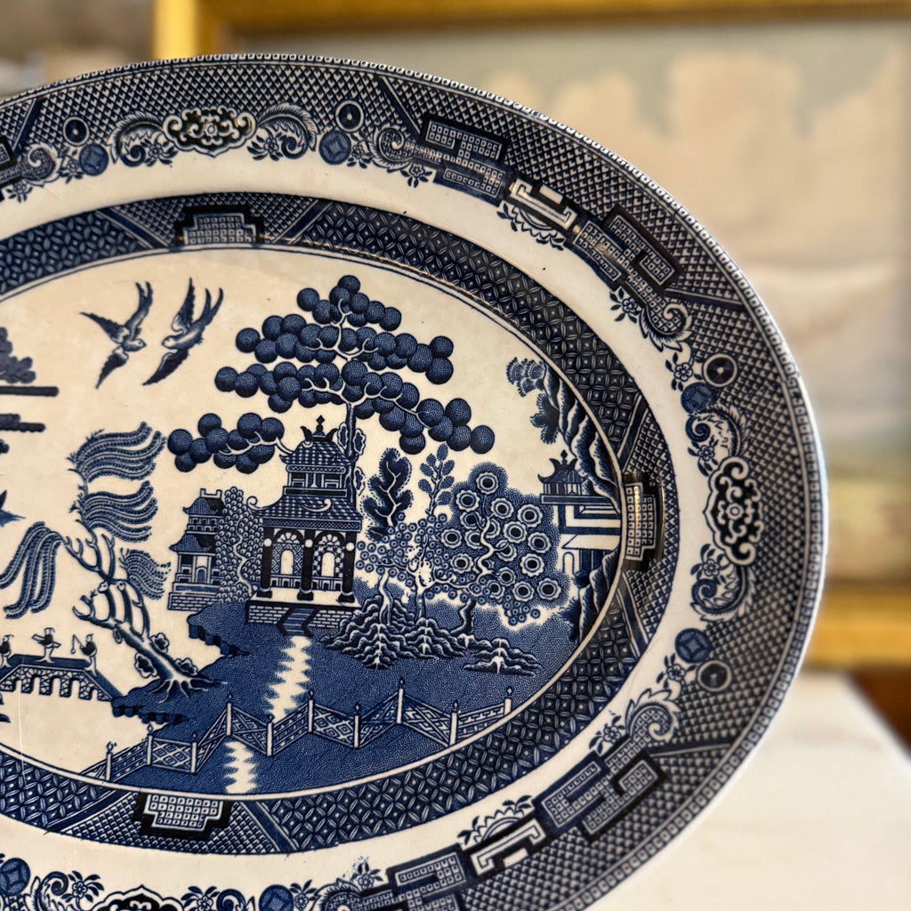 Close-up of the Blue Willow transferware design showing the bridge and two doves.