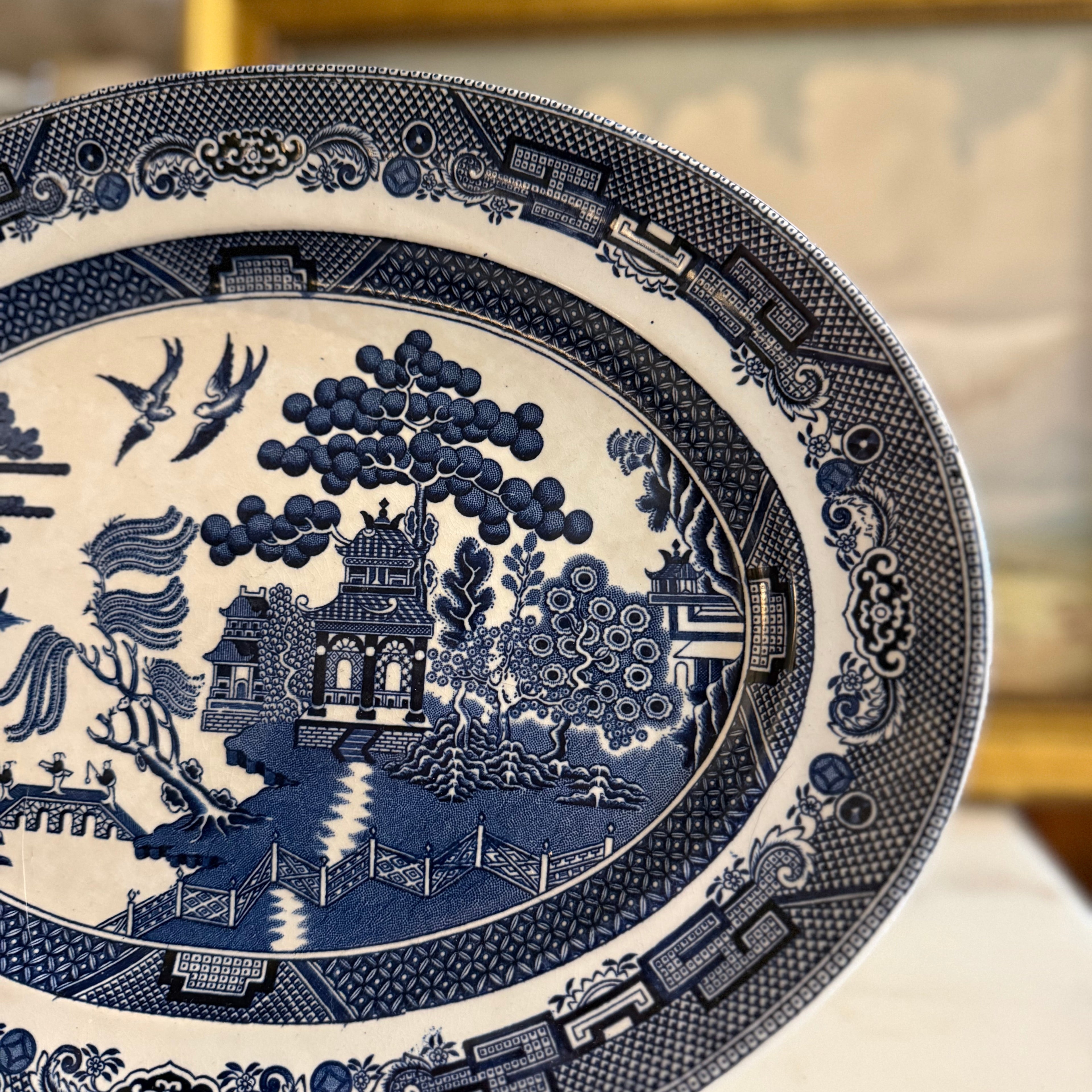 Close-up of the Blue Willow transferware design showing the bridge and two doves.