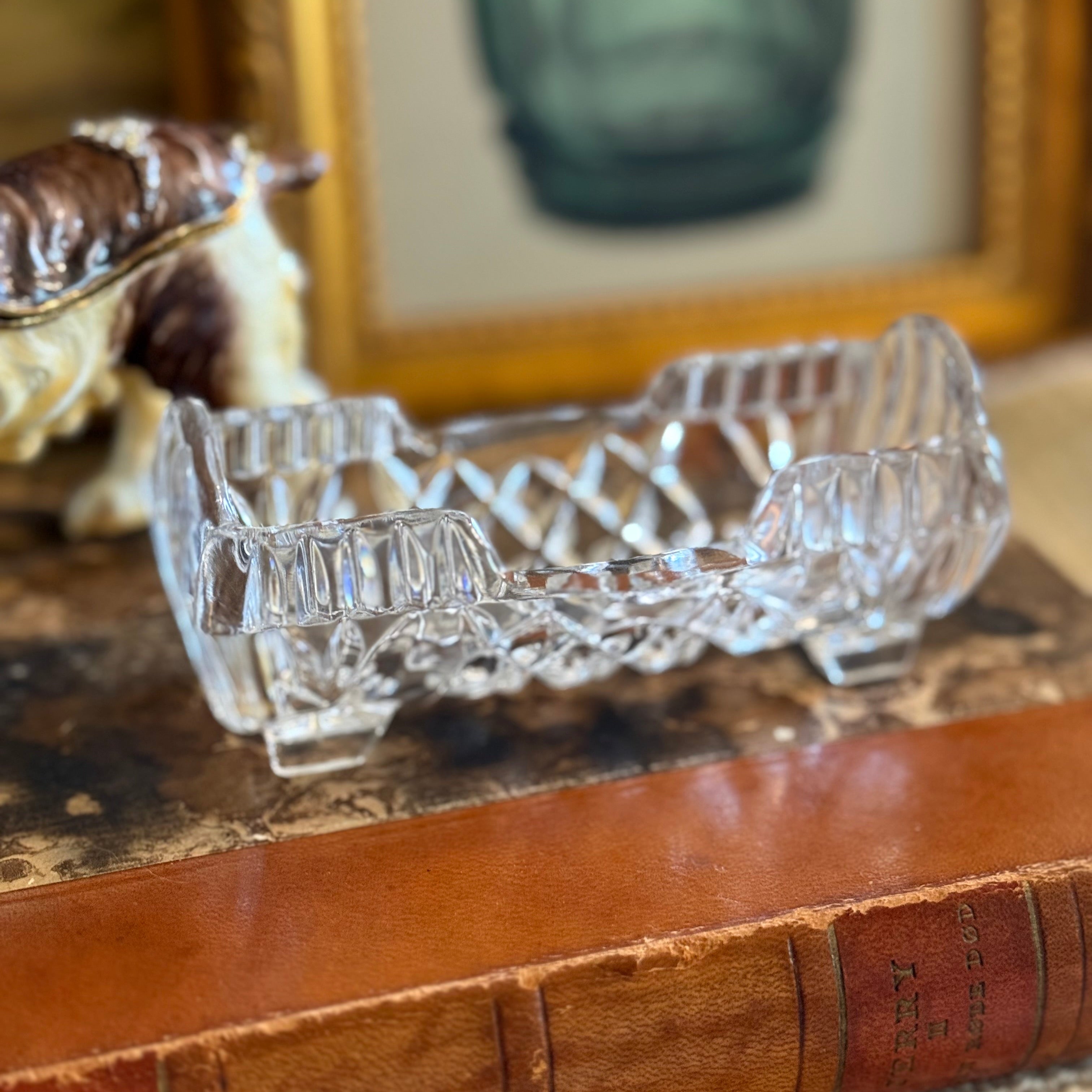 Clear glass toothpick dish on a antique leather book with a blurred background