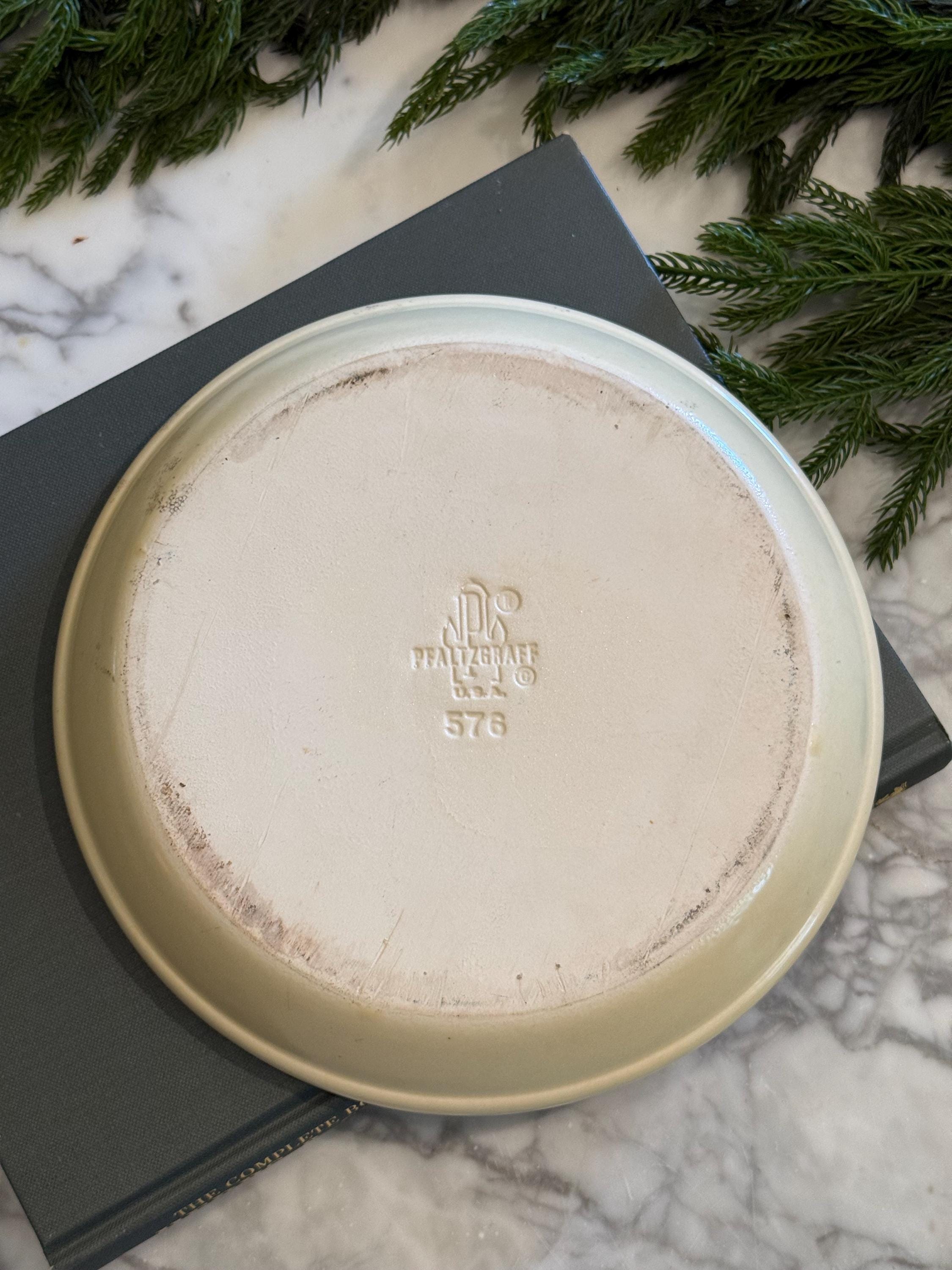 Close-up photo of the bottom of the Pfaltzgraff Village ceramic pie plate, showing the authentic vintage maker's mark stamp that reads "Pfaltzgraff Copyright USA.