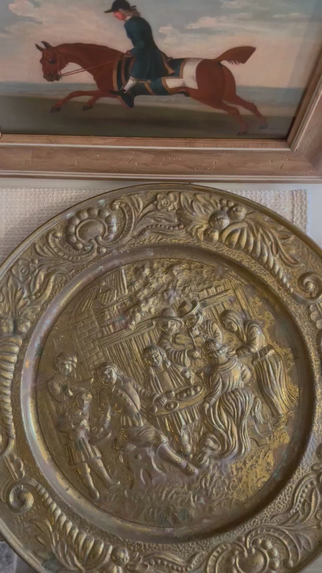 upclose of english brass wall plate with a tavern depiction 