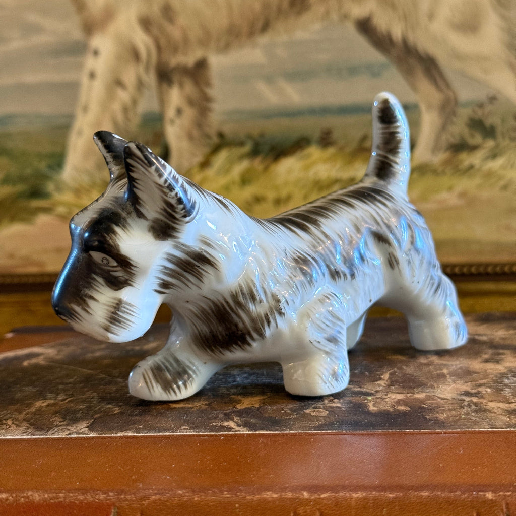 Three-quarter front view of the vintage ceramic Scottie figurine, with an endearing facial expression and small, perky ears.