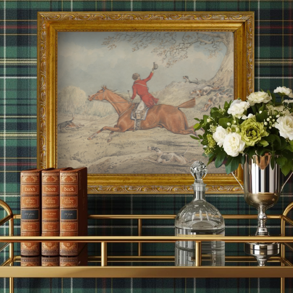 Equestrian-themed gallery wall featuring a traditional fox hunting portrait in a sophisticated home office.