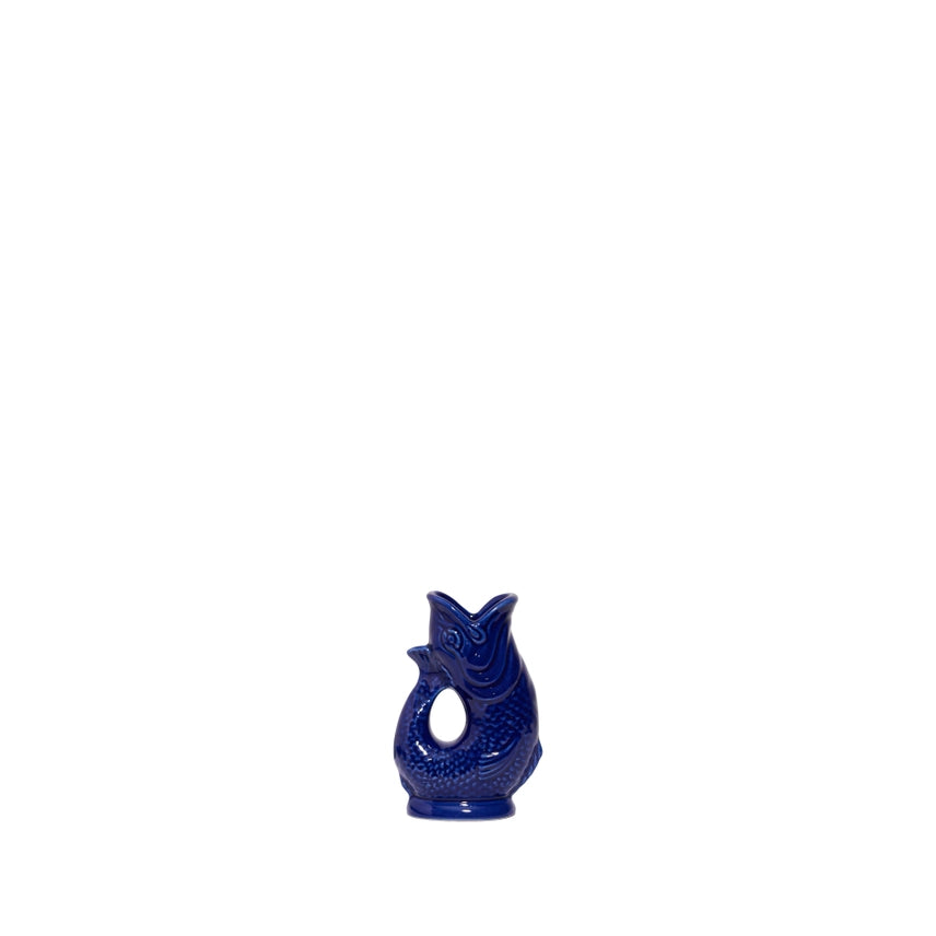 An authentic Mini Cobalt Blue ceramic fish-shaped Gluggle Jug pitcher, standing on a clean white background.