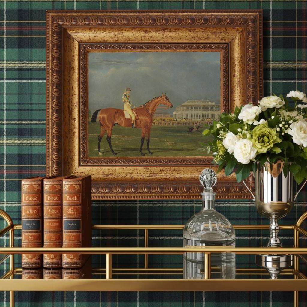 Decorative interior setting with a framed painting of a horse, books, and flowers against a plaid wall.