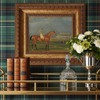 Decorative interior setting with a framed painting of a horse, books, and flowers against a plaid wall.