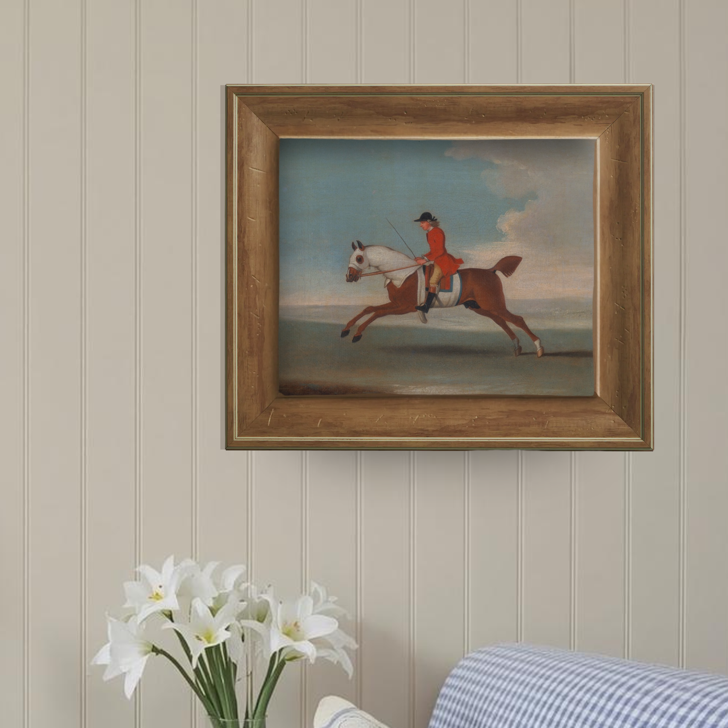 Traditional equestrian artwork in an English pine frame styled on a gallery wall in a classic home office.