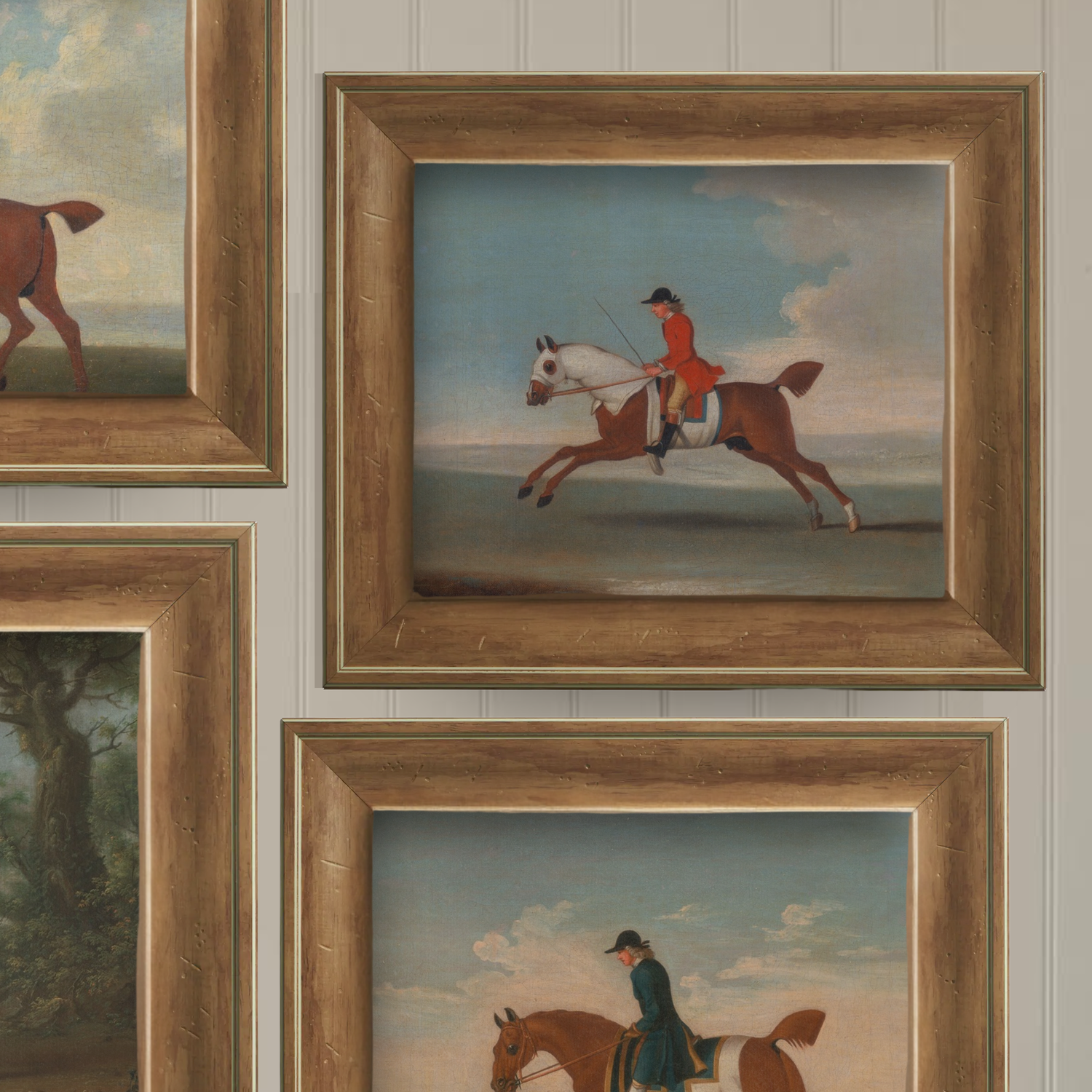 Framed paintings of equestrian scenes on a wall.