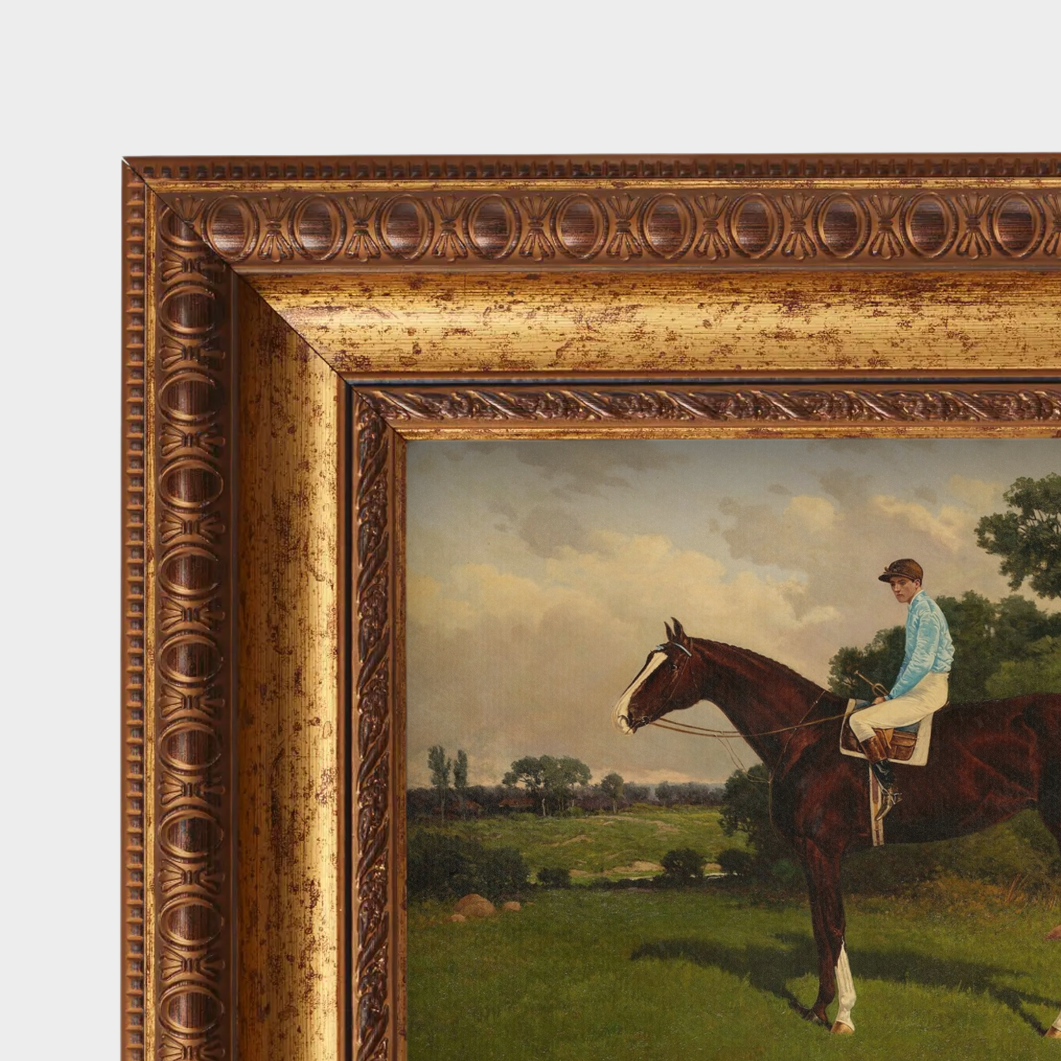 Framed painting of a jockey on a horse in a pastoral setting