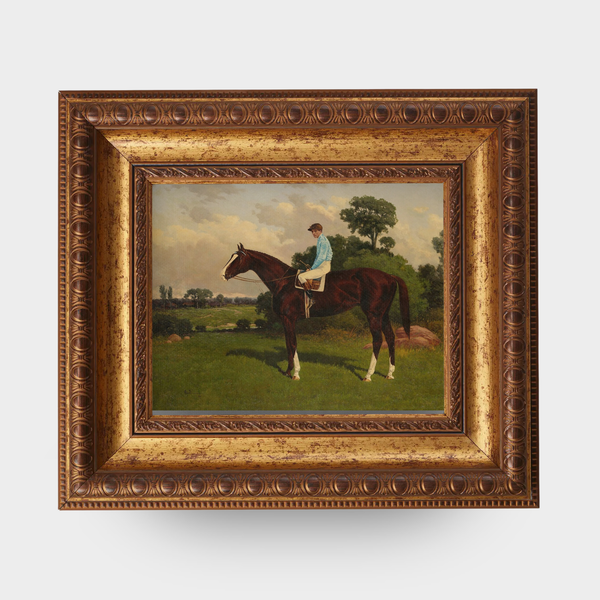Painting of a derby jockey race horse in a decorative gold frame