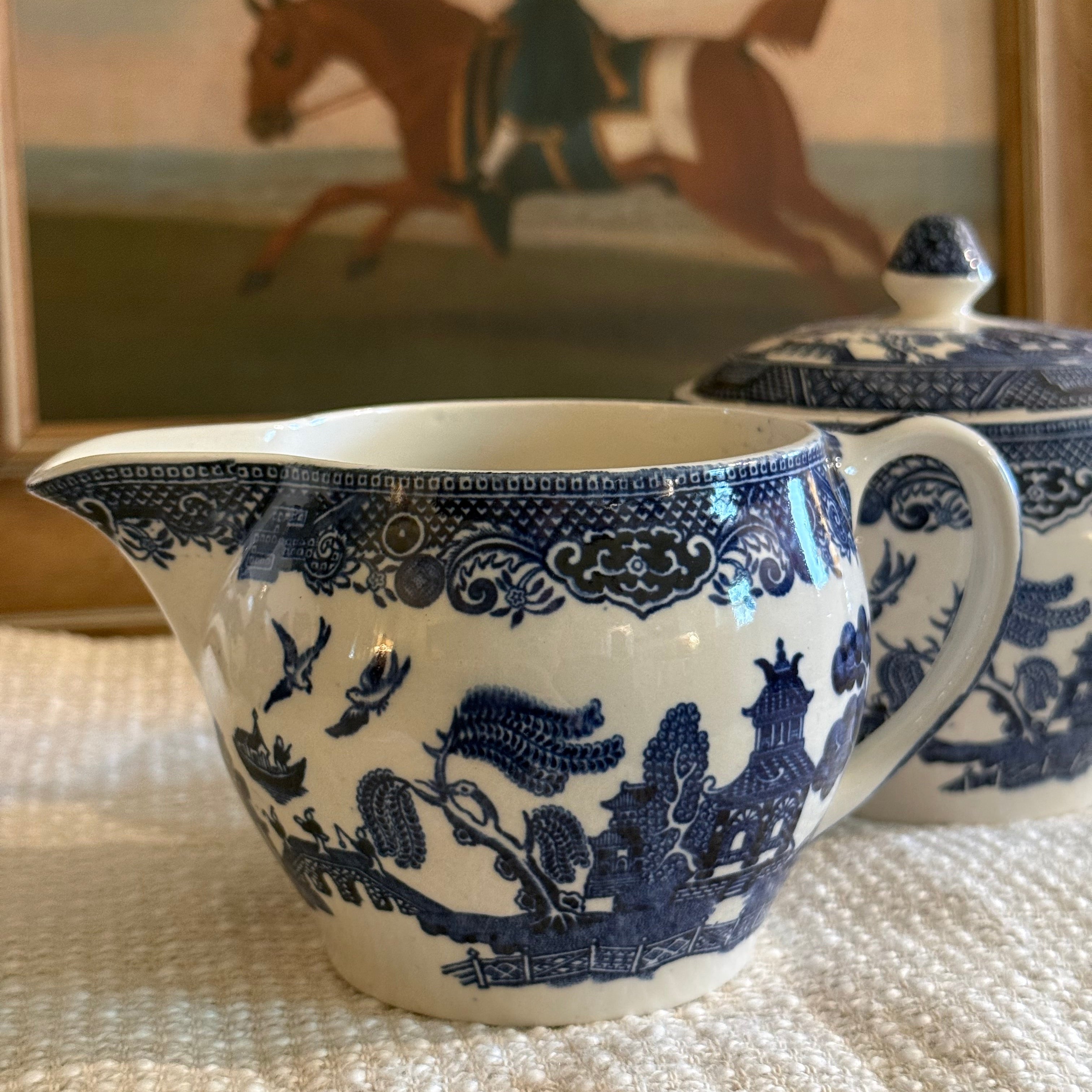 Detail view of the cobalt blue willow transferware pattern on an English creamer.