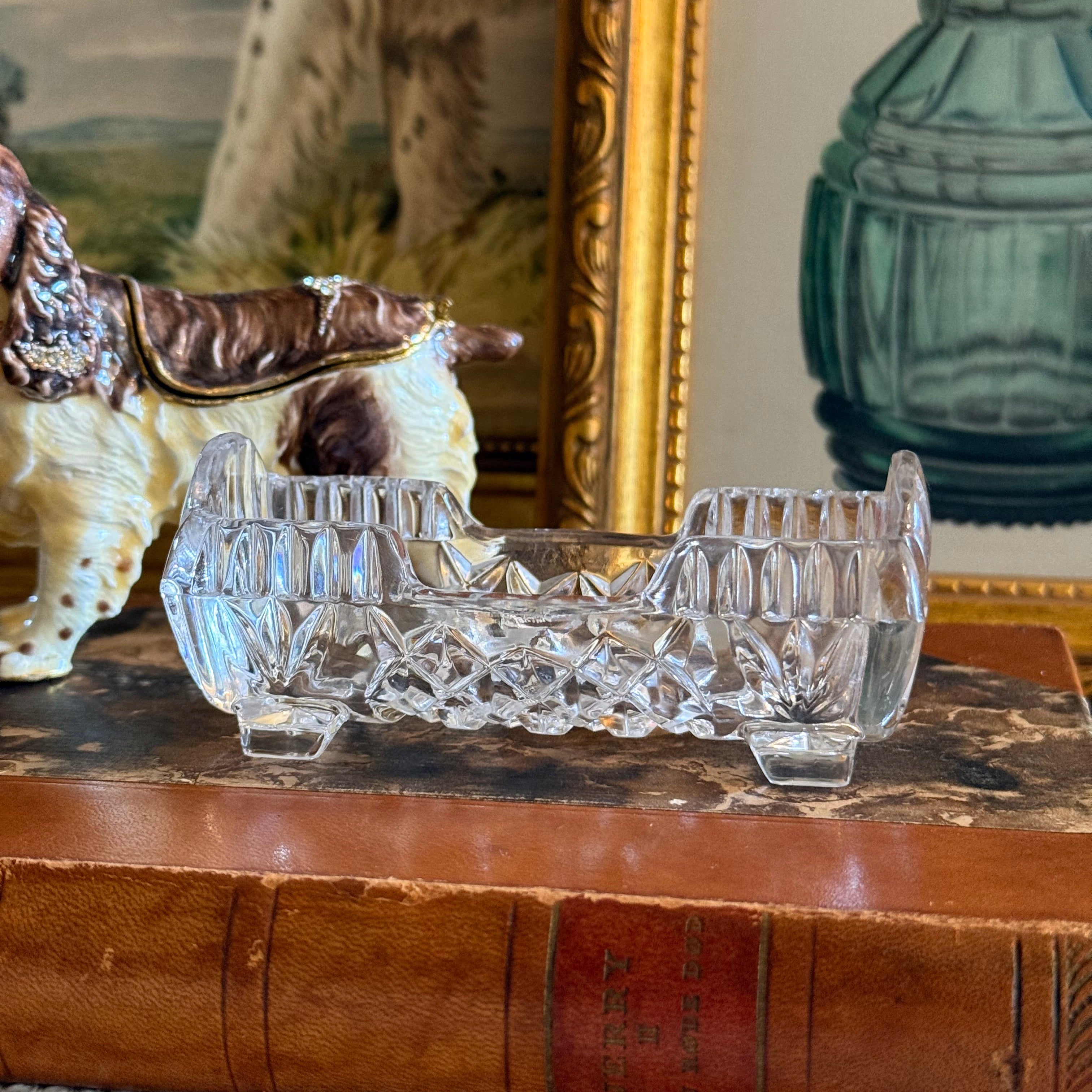 Decorative crystal toothpick holder with intricate design on a textured surface