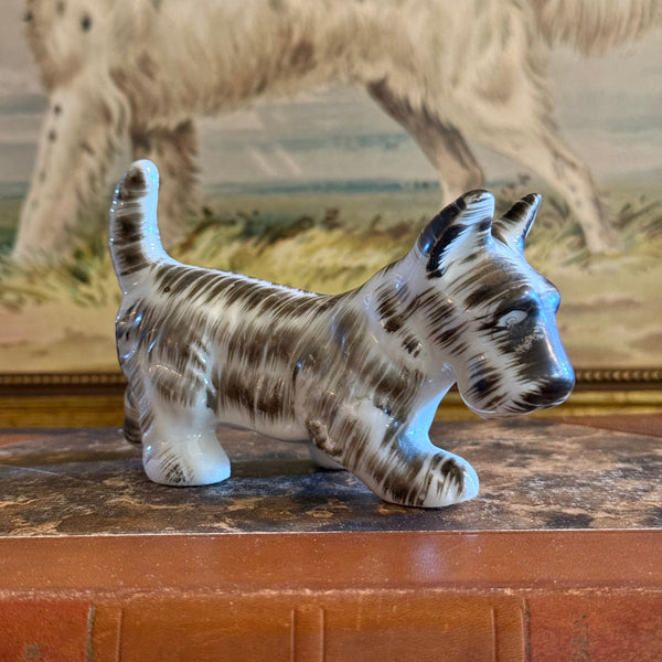 Charming side profile view of the detailed vintage ceramic Scottish Terrier figurine, showcasing its textured blue-grey glaze and painted details.